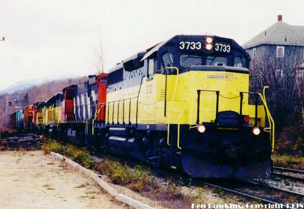 Photo of St.Lawrence & Atlantic's 3733 leads a northbound freight into Berlin, NH.