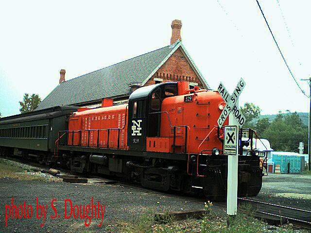 Photo of former New Haven engine at head of Naugatuck RR train