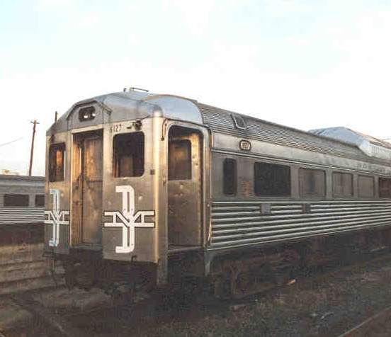 Photo of RDC Buddliner awaiting disposal next to Fitchburg Line in Cambridge.