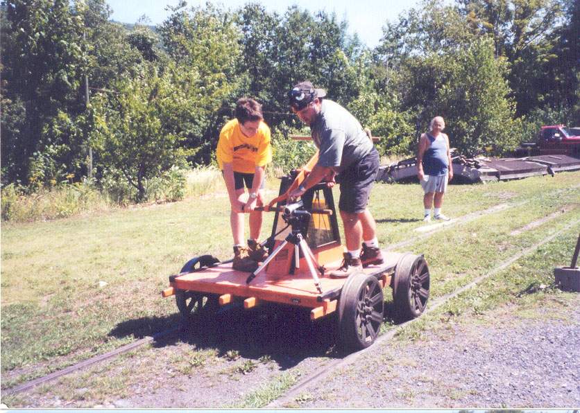 Photo of JB Mentzer riding the handcar at the W End picnic