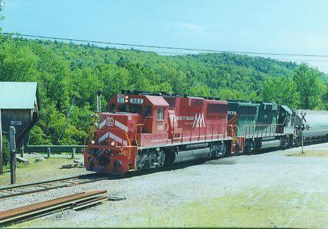 Photo of GP60's #381 & 382 passing the covered bridge at Bartonsville, VT.