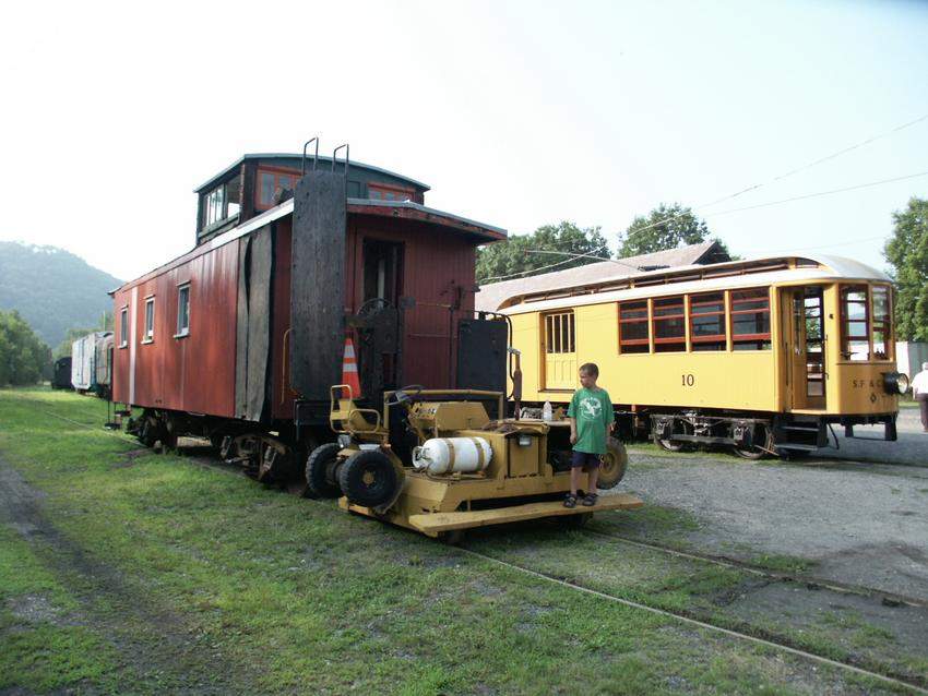 Photo of SFTM Number ten and nearly restored wooden caboose