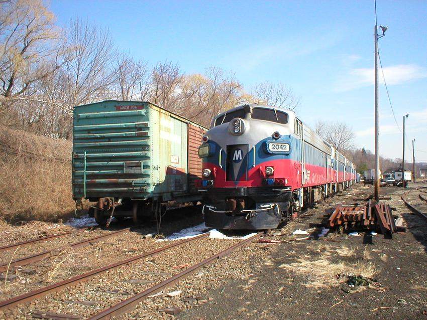 Photo of Metro-North FL9AC-DM 2042 basks in the morning sun in the deadline.