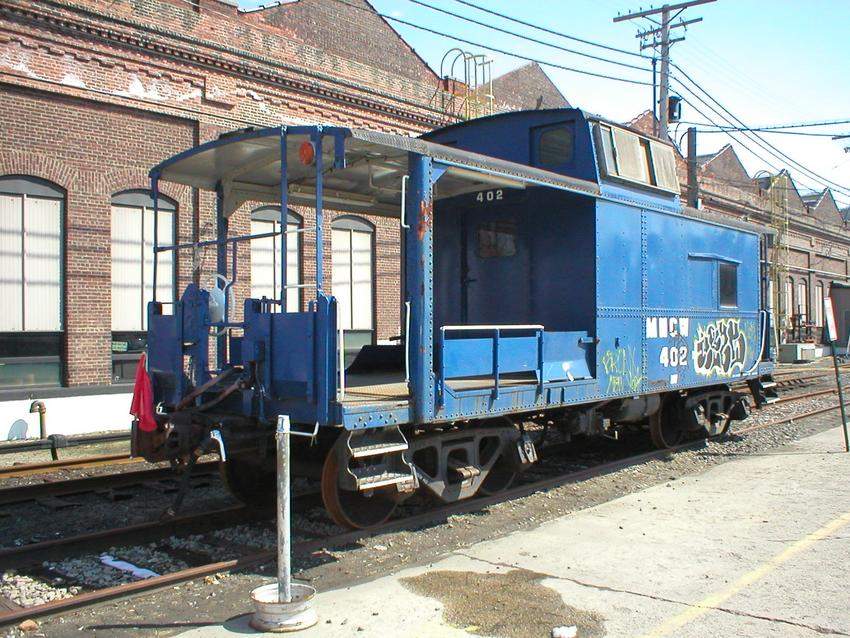 Photo of Metro-North caboose 402 was converted to house snowblowers on the porch.