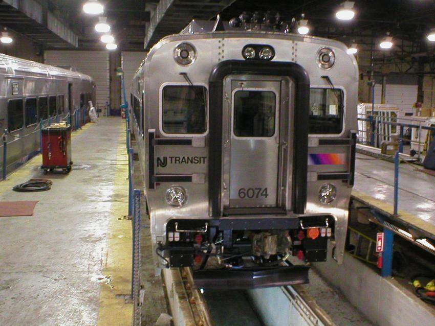 Photo of NJT Comet V cab car 6074 sitting over the pit in the Alstom facility.