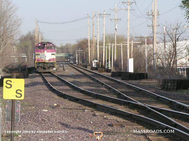 Photo of MBTA Commuter Rail train #233 approaches the single track at Ash Street