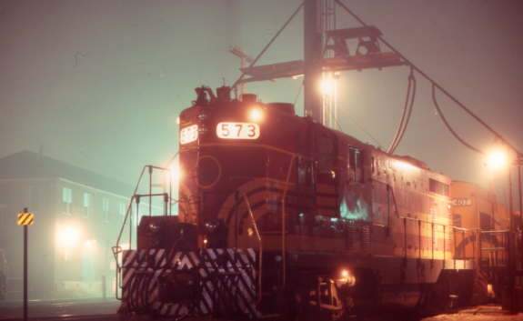Photo of MEC #573 under lights in fog.