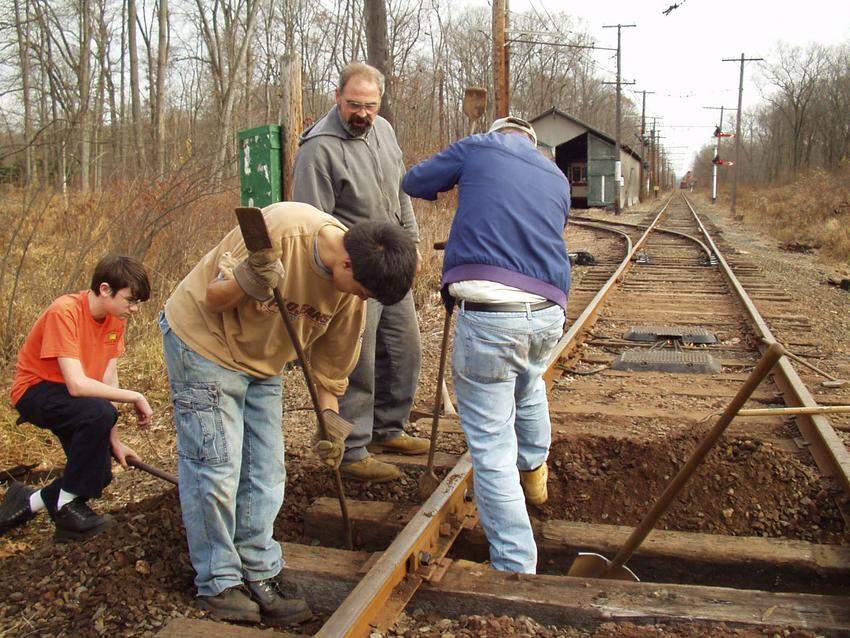 Photo of A group of friendly volunteers helping out to replace a tie