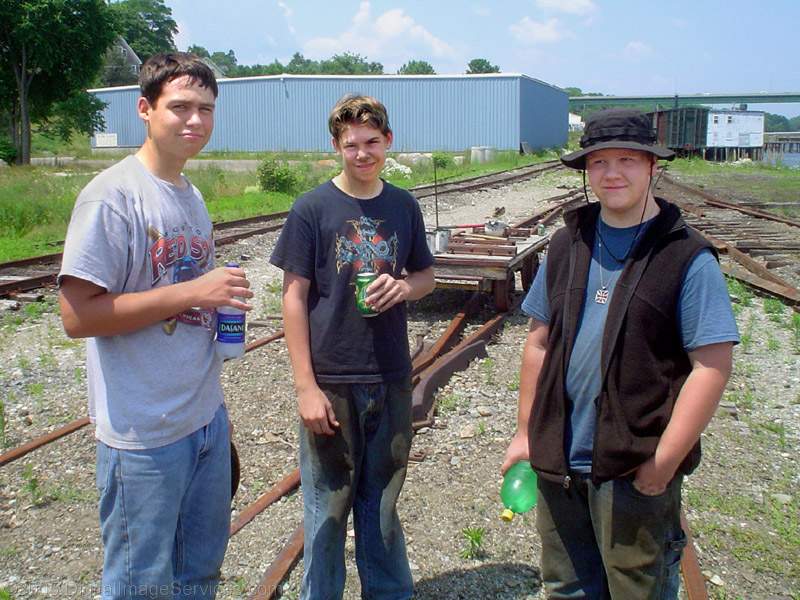 Photo of The trackcrew takes a break from pulling up the rails in the Belfast, ME, yard.