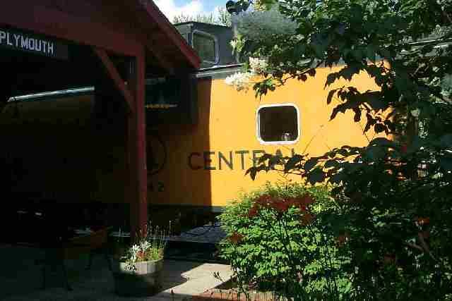 Photo of MEC caboose nestled up to the station