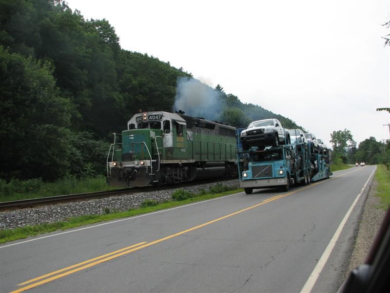 Photo of Truck racing train.   Train looses