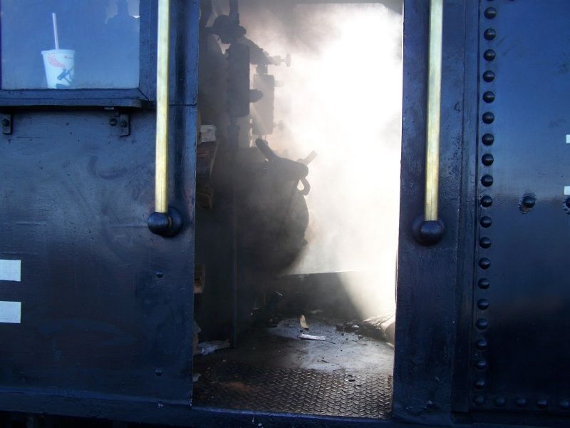 Photo of Inside the cab of #4 as the wood fire starts to burn in the firebox.