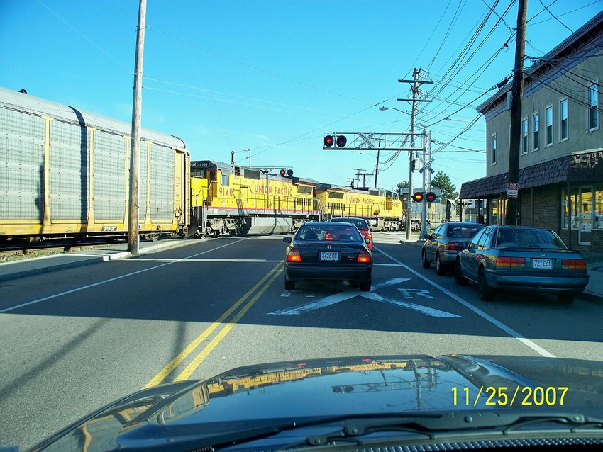 Photo of Autorack train crossing in front of the autos.