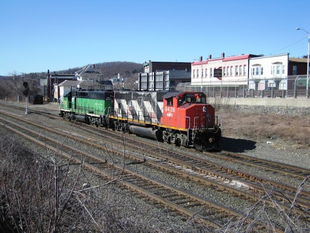 Photo of Two NECR locomotives pull away after an Amtrak meet