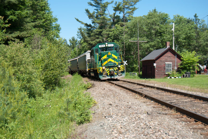 Photo of WACR train NPWJ passing the former CP car house West Burke, VT.
