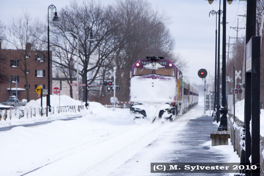 Photo of MBTA 1030 covered in snow heading Inbound