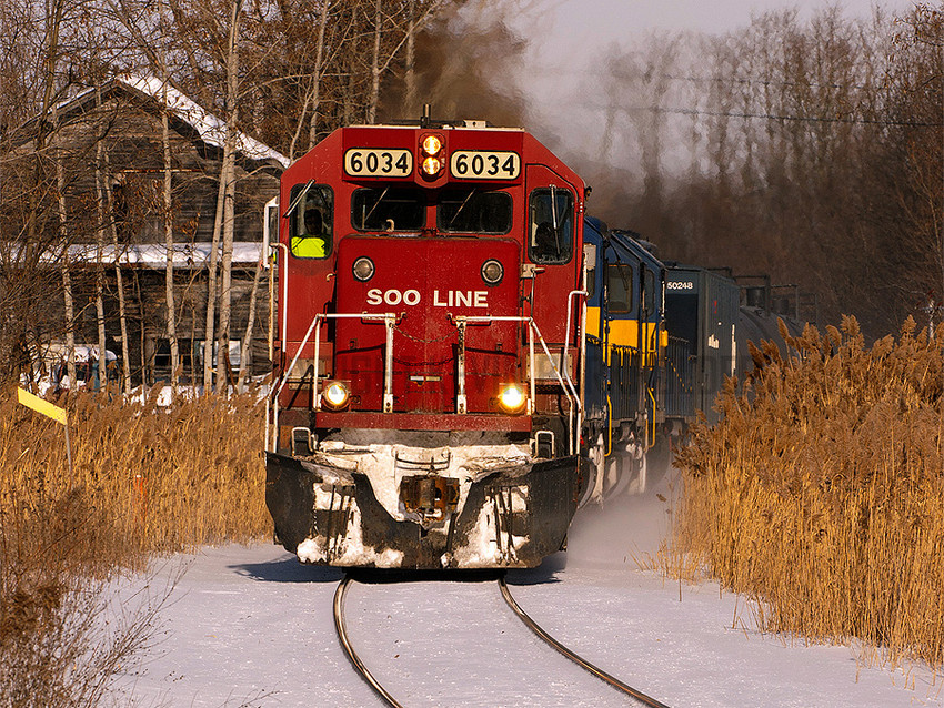 Photo of CPR 666-801 Passes an Aged Structure in Crown Point