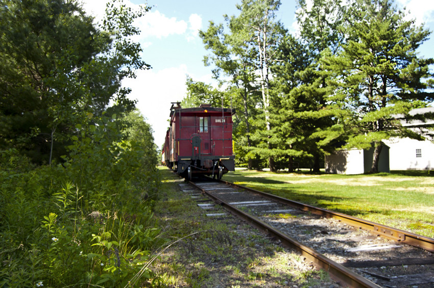 Photo of BML train passing through a City Point, ME, front yard.