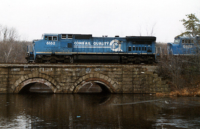 Photo of Conrail C40 crossing Brackett Reservoir Ashland, MA