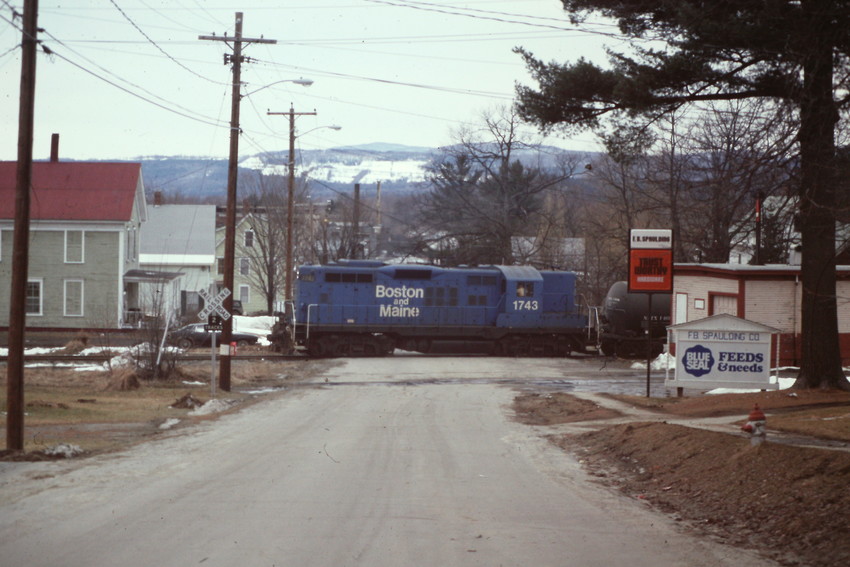 Photo of B&M Groveton switcher passing the freight house in Lancaster,NH in 1984