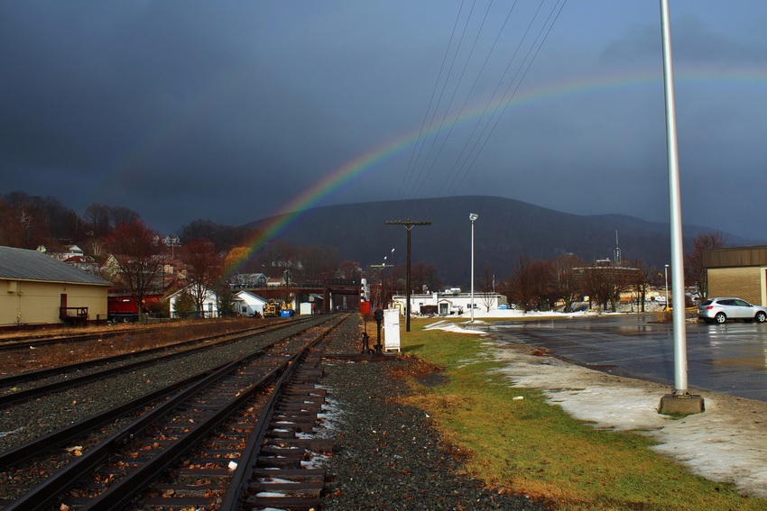 Photo of Rainbow over the tracks on a dark day