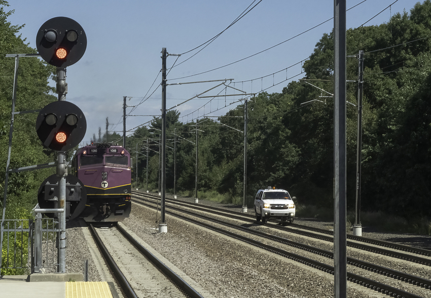 Photo of MBTA Train 820 Passing Amtrak Hi-Rail Vehicle as It Heads to Boston